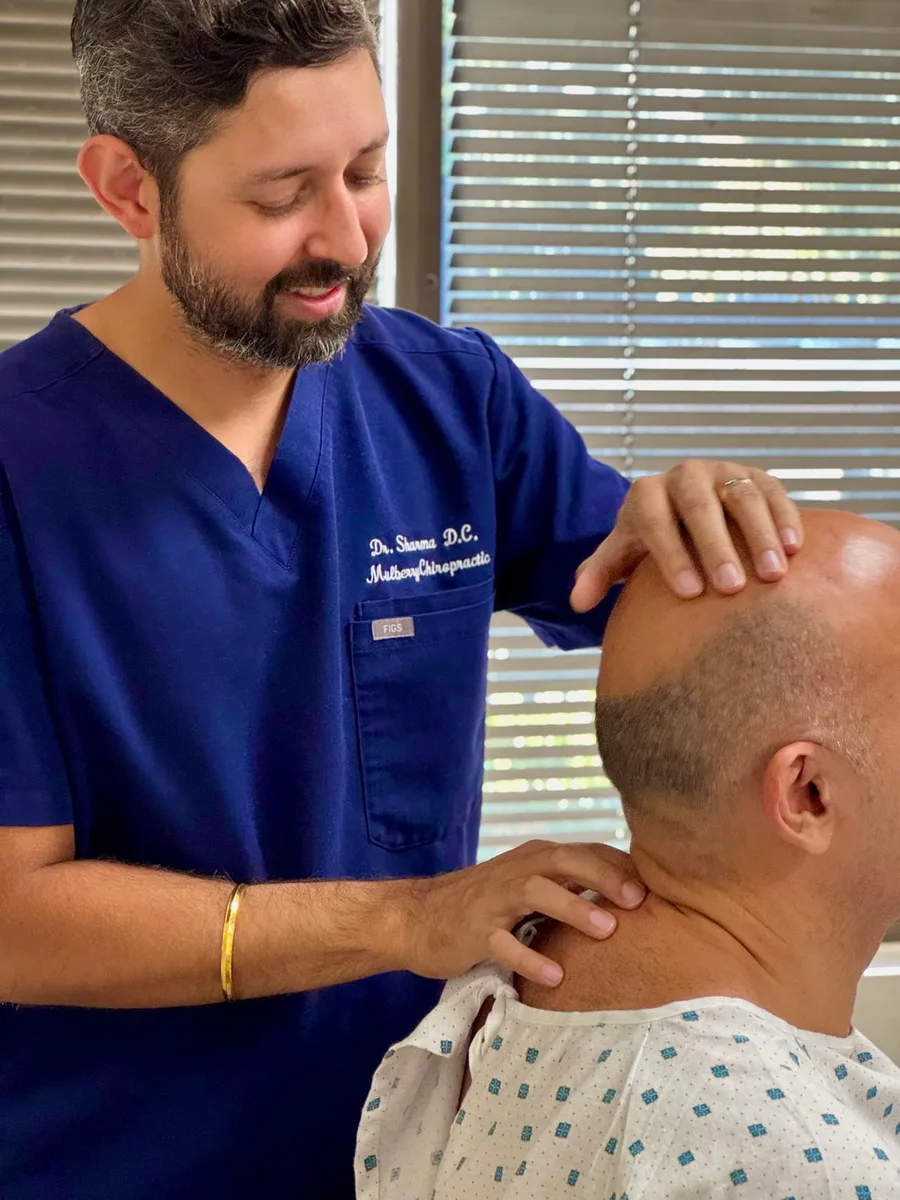 Dr. Richard Sharma adjusting a patient at Mulberry Chiropractic in Houston